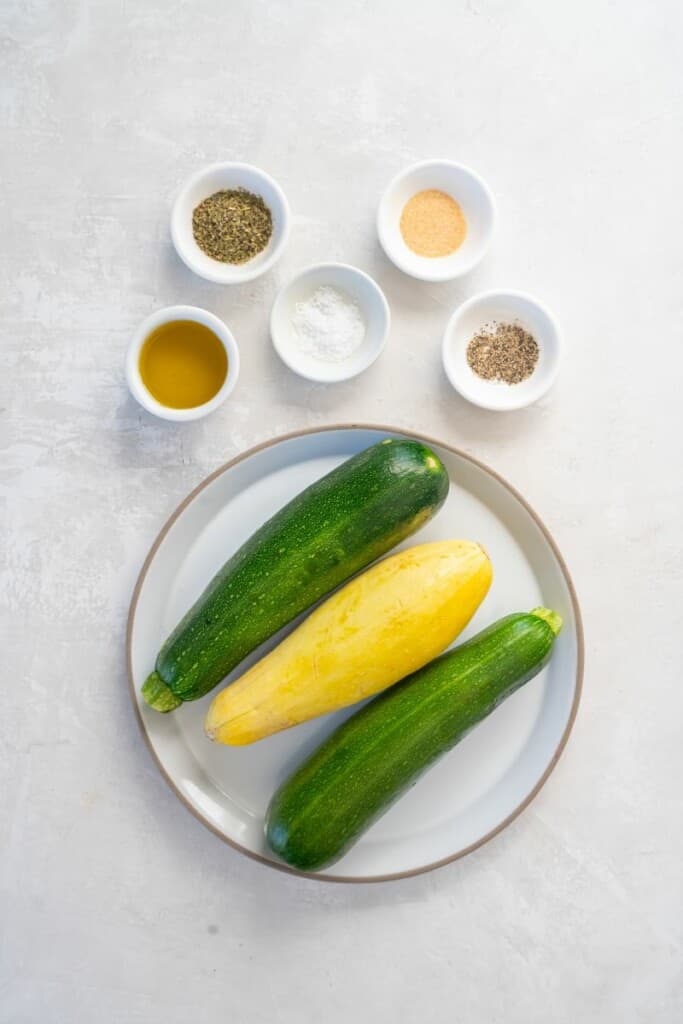 Overhead view of ingredients needed to prepare air fryer squash and zucchini.