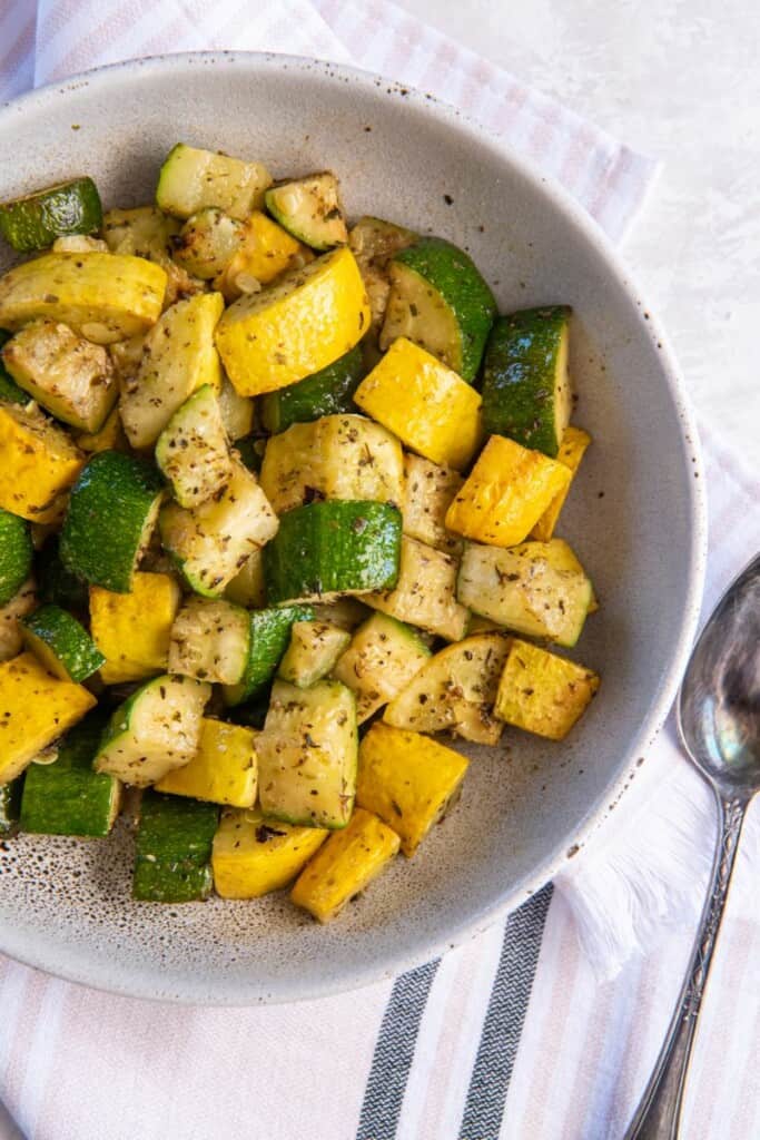 Overhead view of Air Fryer Squash and Zucchini in a white bowl.
