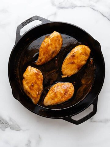 Cooked chicken breast in cast iron skillet