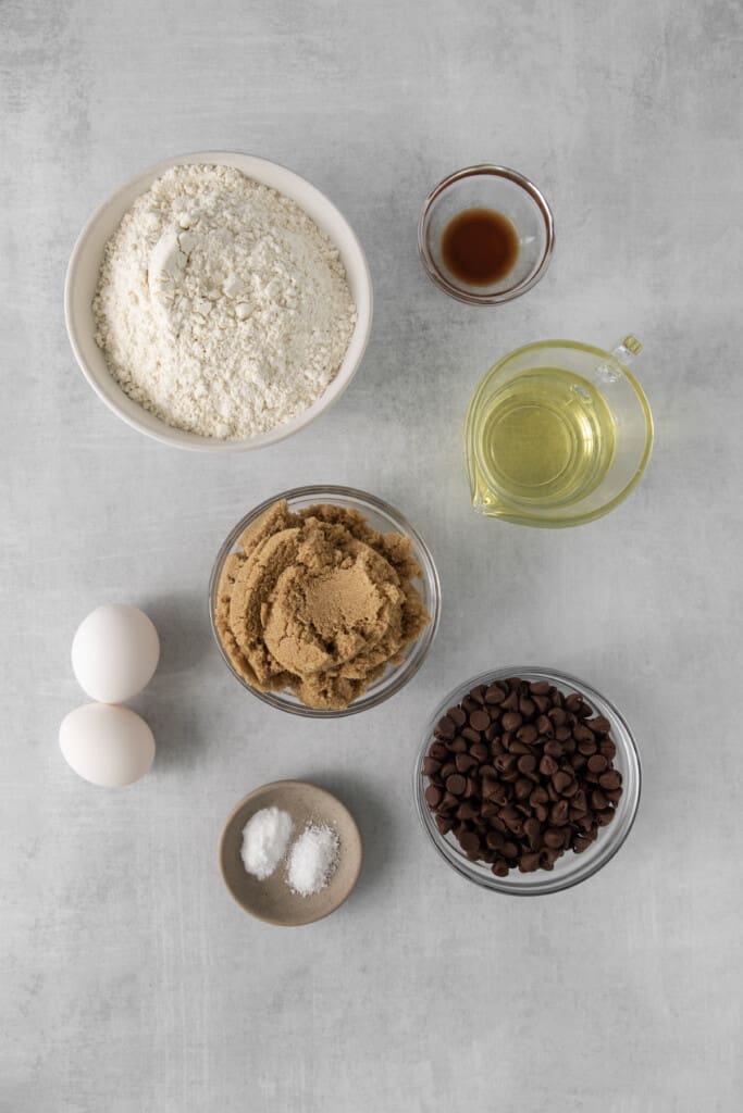 Vertical view of all the ingredients required to make Chocolate Chip Cookies with No Butter.