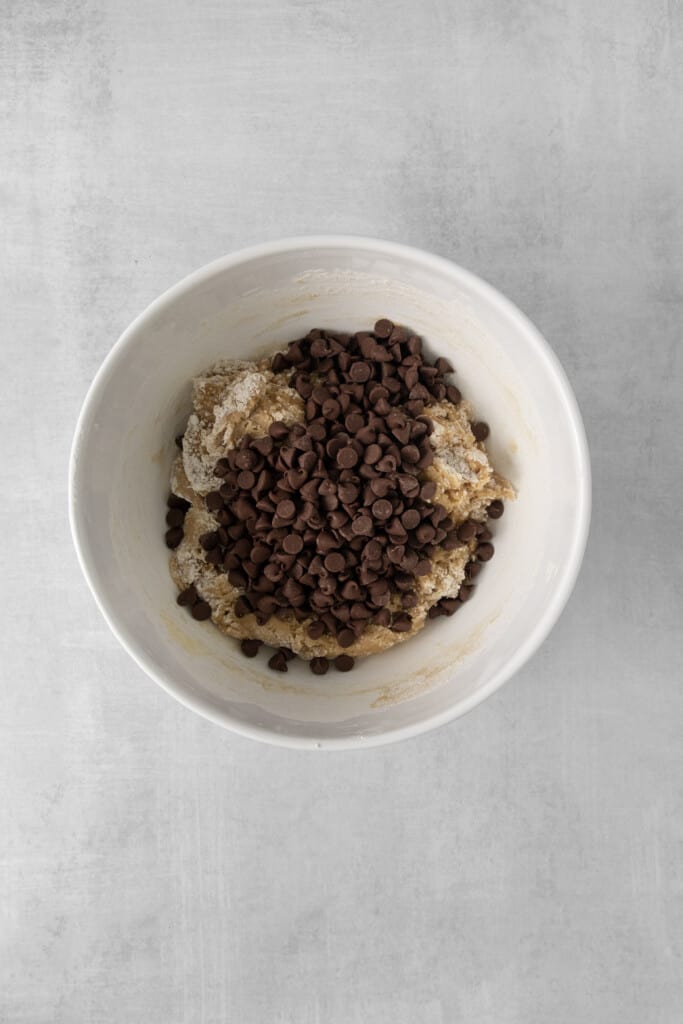 Overhead view of of baking soda, salt, flour, and chocolate chips before they are mixed.