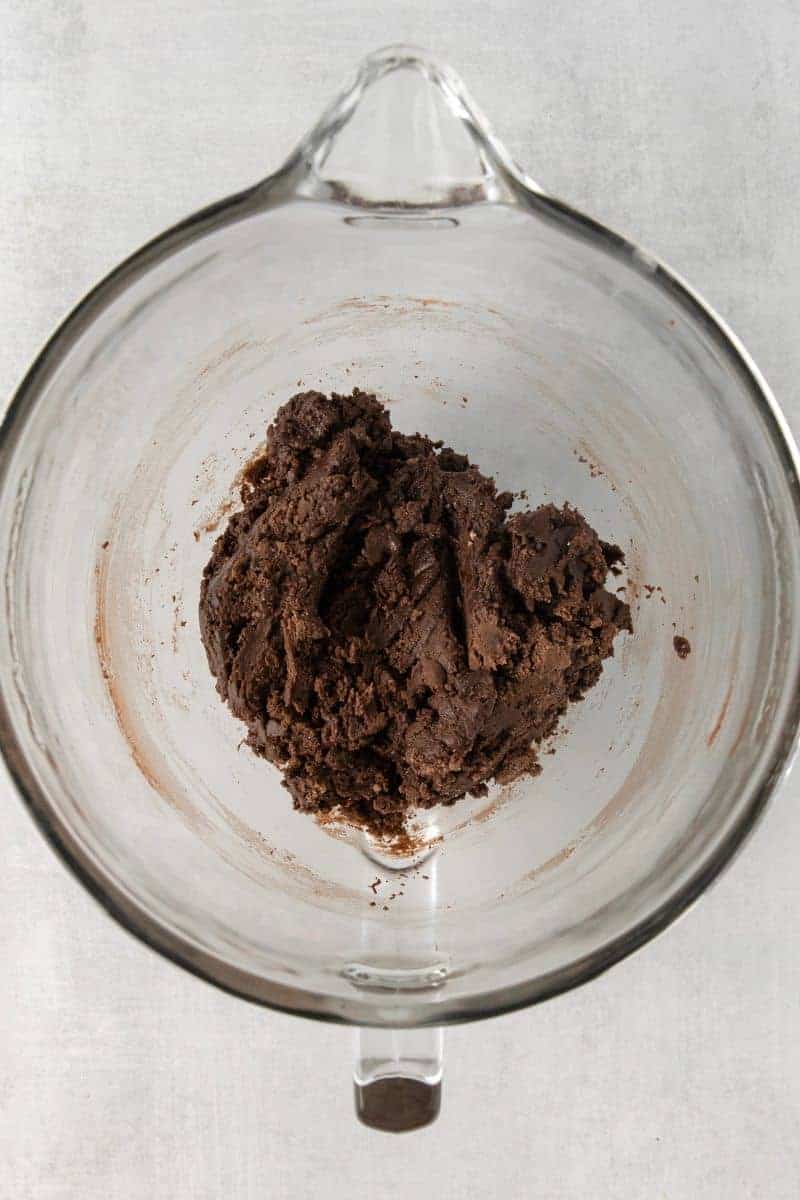 Overhead view of mixed ingredients for edible brownie batter in a blender.