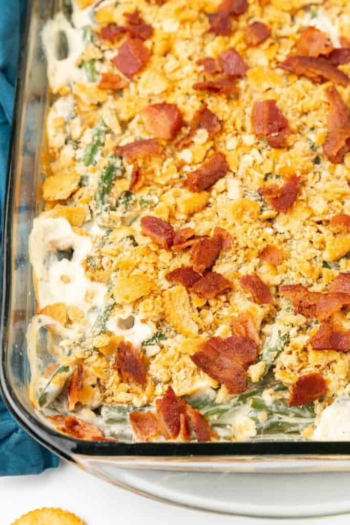 Close up view of green bean casserole in a clear 9x13 baking dish.