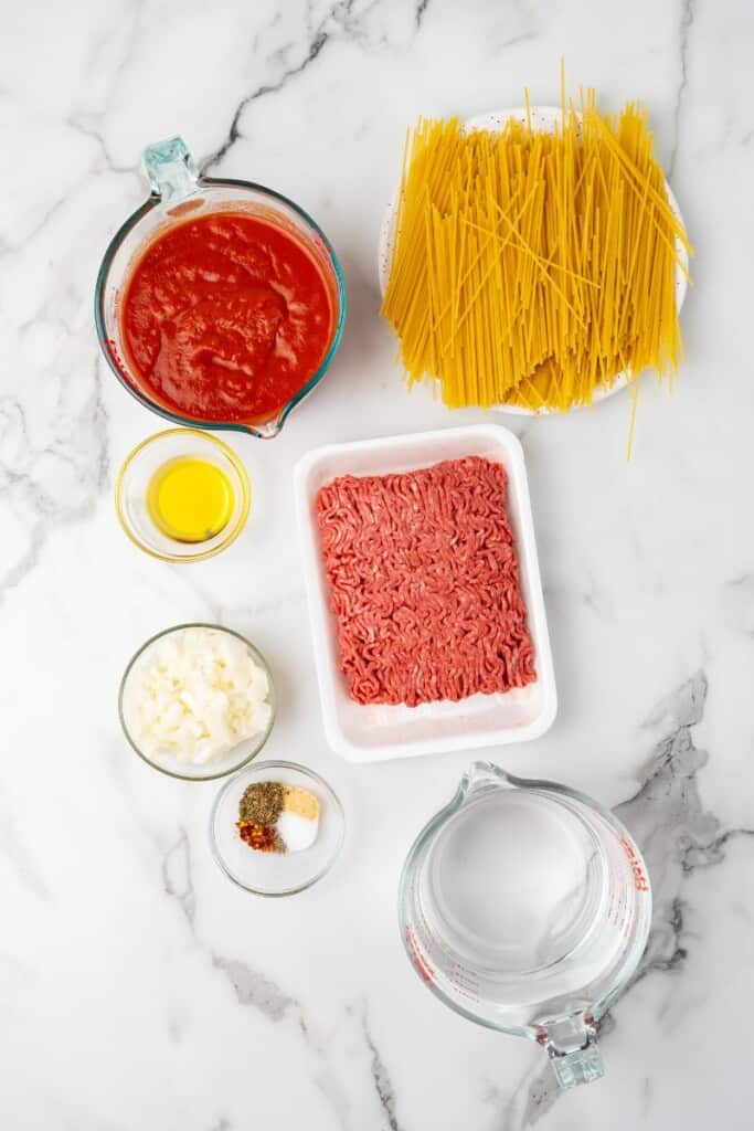 Overhead view of ingredients needed to prepare spaghetti in the Ninja Foodi.