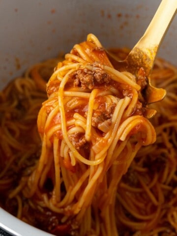 Spoon scooping spaghetti out of the Ninja Foodi.