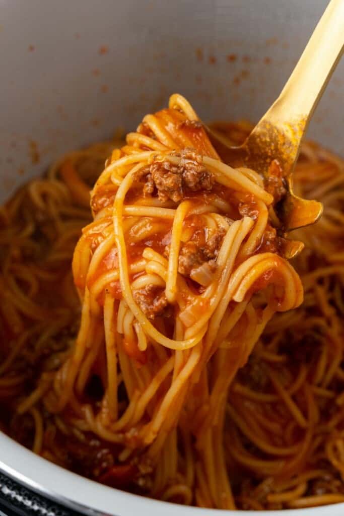 Spoon scooping spaghetti out of the Ninja Foodi.