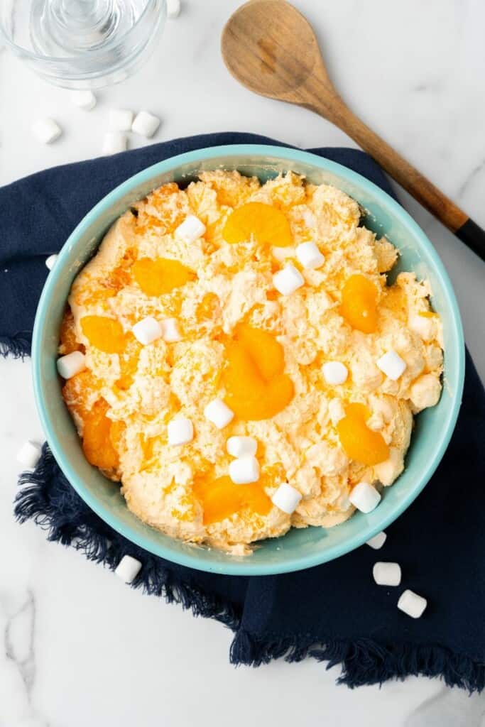 Overhead view of a blue bowl full of Orange Dreamsicle Salad.