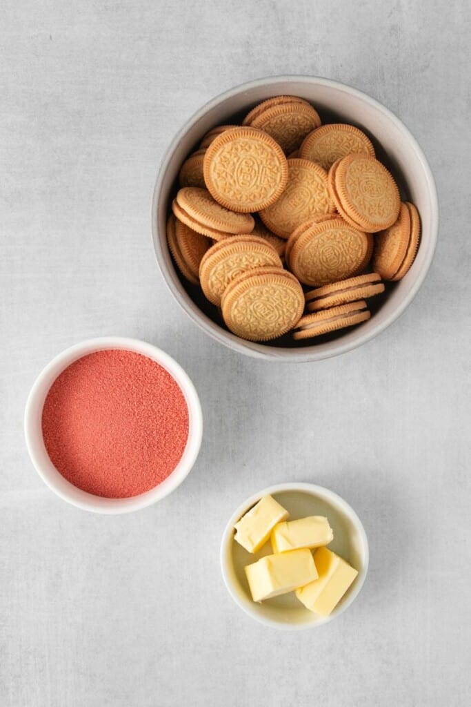 The ingredients needed to make Strawberry Crunch. Golden Oreos, butter, strawberry gelatin.