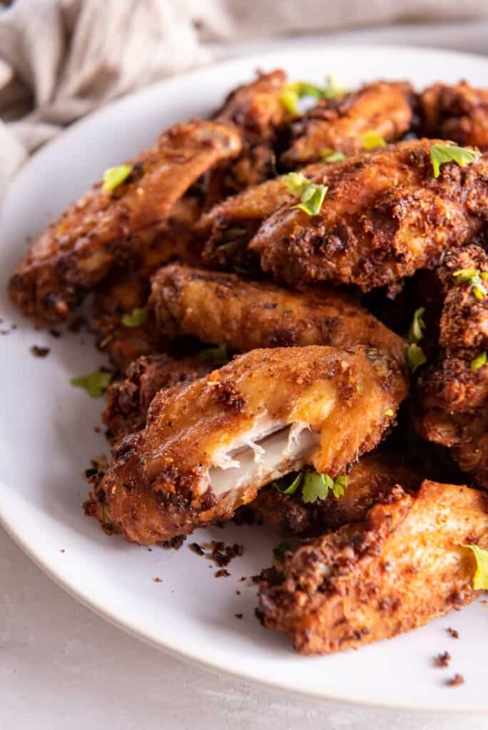 Chicken Wings prepared in the air fryer on a white plate.