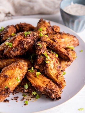 Crispy Chicken Wings cooked in the air fryer on a white plate.