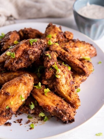 Crispy Chicken Wings cooked in the air fryer on a white plate.