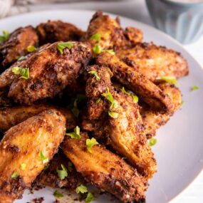 Crispy Chicken Wings cooked in the air fryer on a white plate.