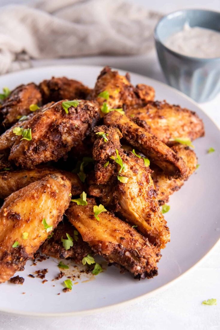 Crispy Chicken Wings cooked in the air fryer on a white plate.