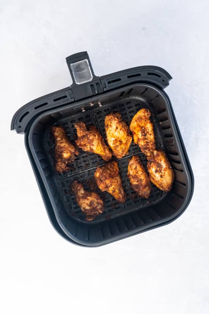 Overhead view of chicken wings in the air fryer basket.