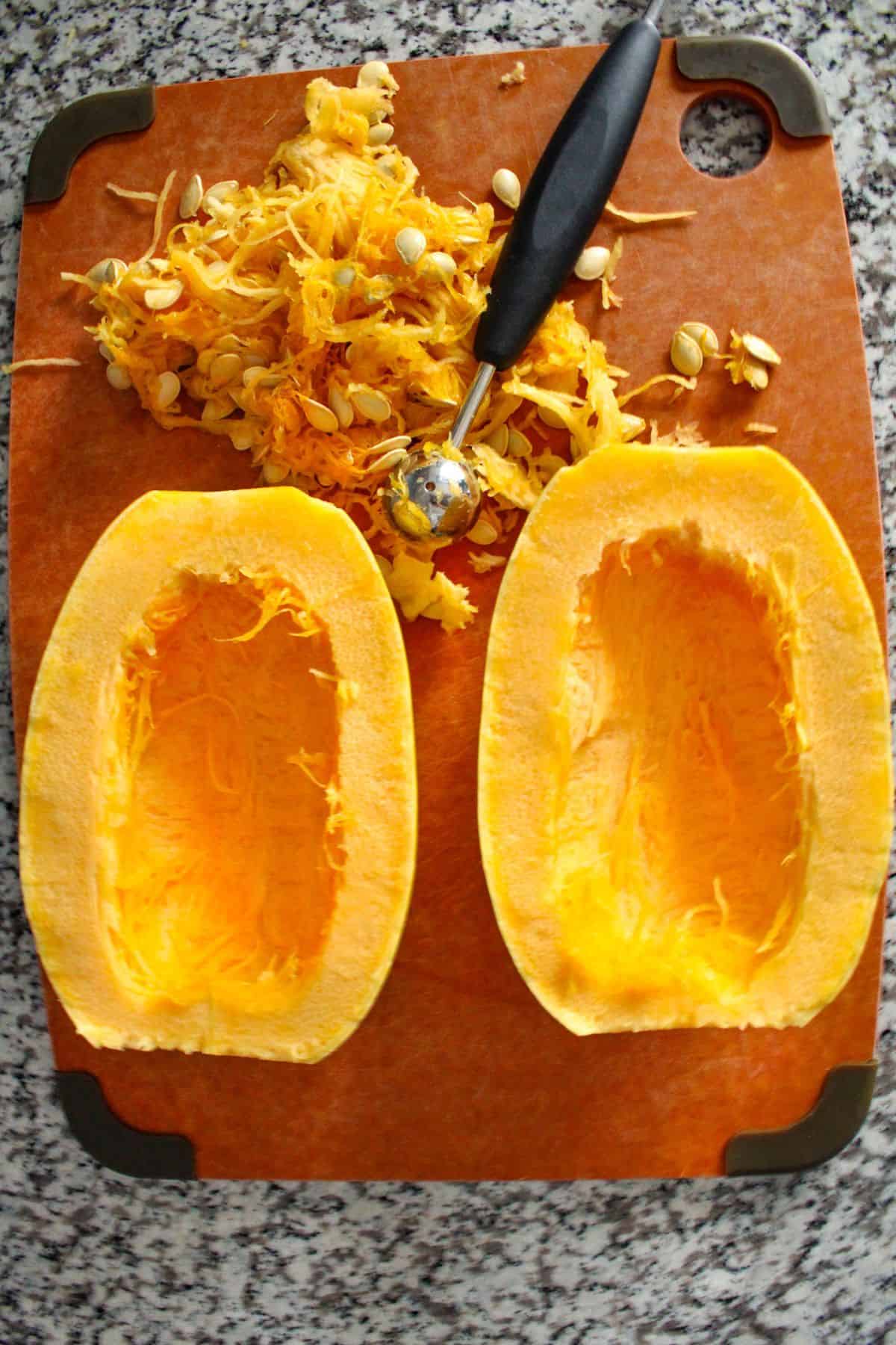 Spaghetti squash cut in half with seeds and middle removed.