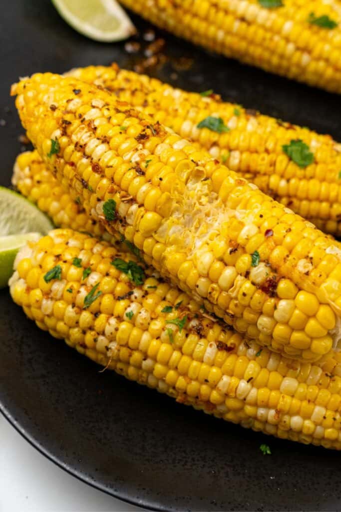 Fresh corn on the cob close up with a bite taken out of the corn.