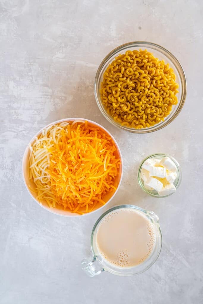 Ingredients needed to prepare 3 ingredient macaroni and cheese in a slow cooker.