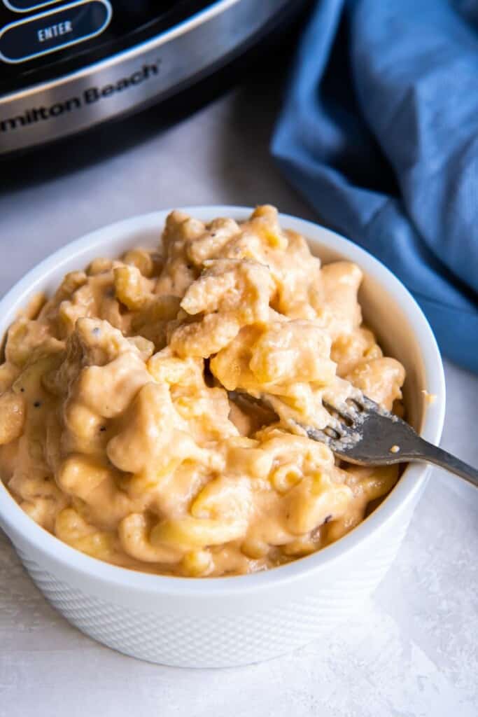 White bowl of 3 ingredient macaroni and cheese prepared in a slow cooker.