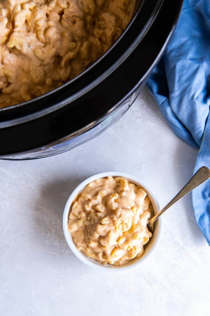 Overhead view of a white bowl of slow cooked macaroni and cheese.