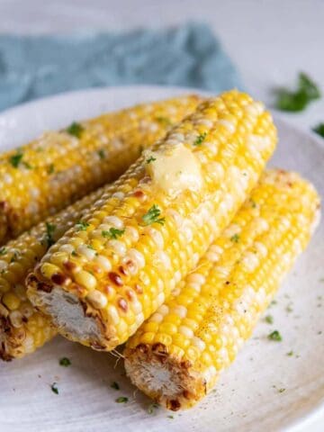 Four delicious ears of corn prepared from frozen in an air fryer.