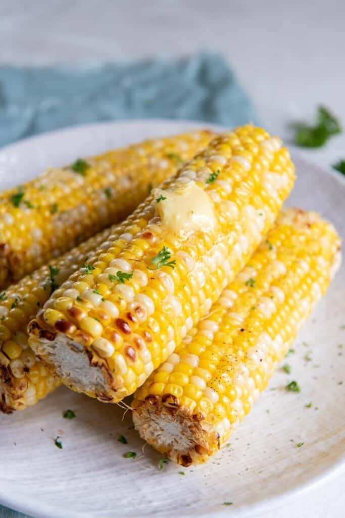 Four delicious ears of corn prepared from frozen in an air fryer.