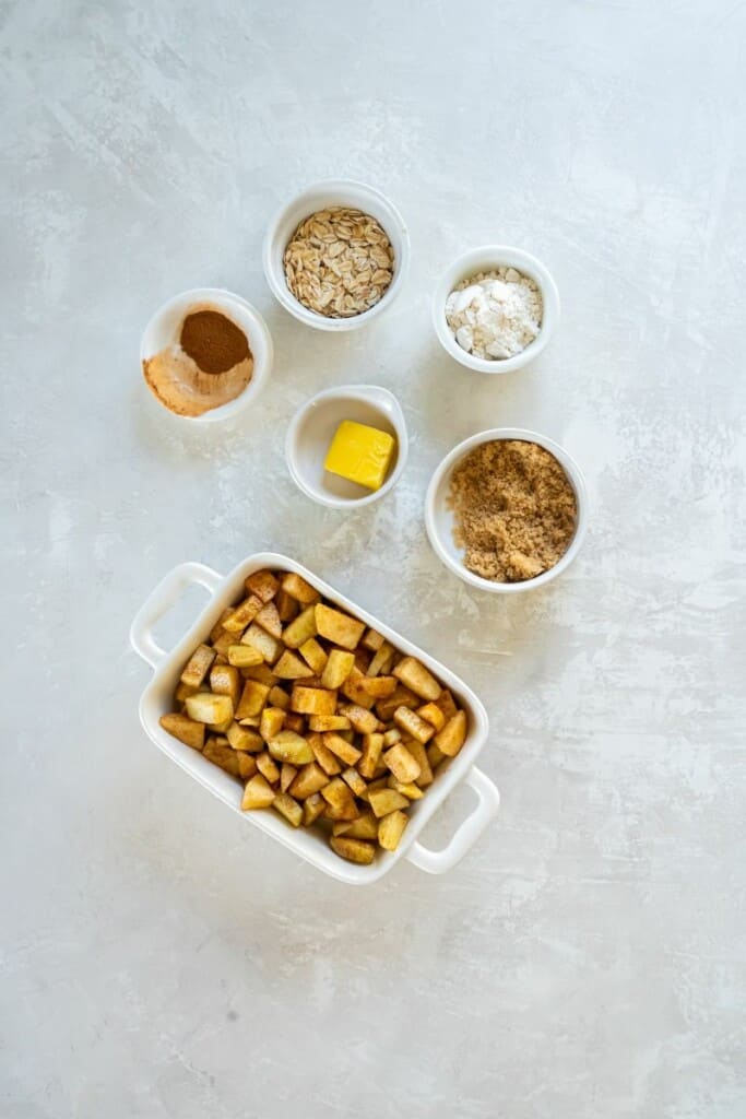 Ingredients needed to prepare an apple crisp in the air fryer.