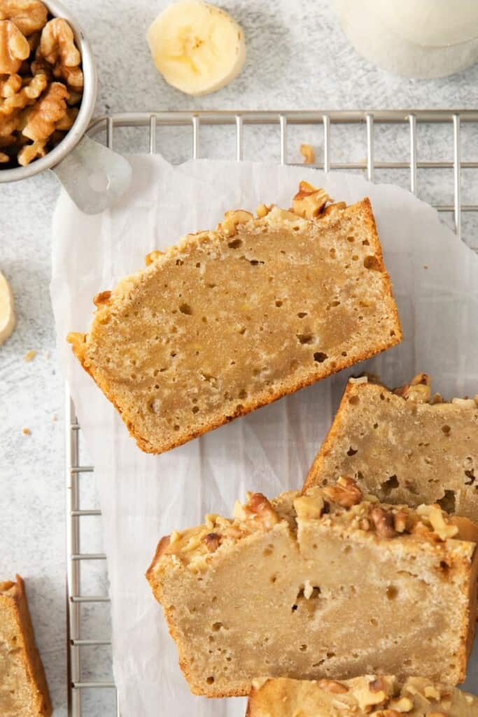 Slices of baked banana bread on a cooling rack.