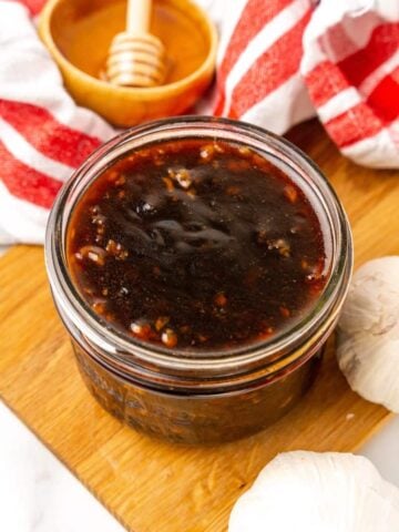 Honey Garlic Sauce in a clear small mason jar.