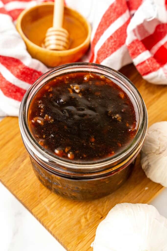 Honey Garlic Sauce in a clear small mason jar.