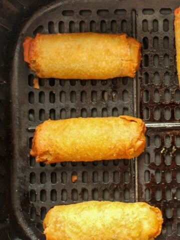 Close up of egg rolls in the air fryer to reheat