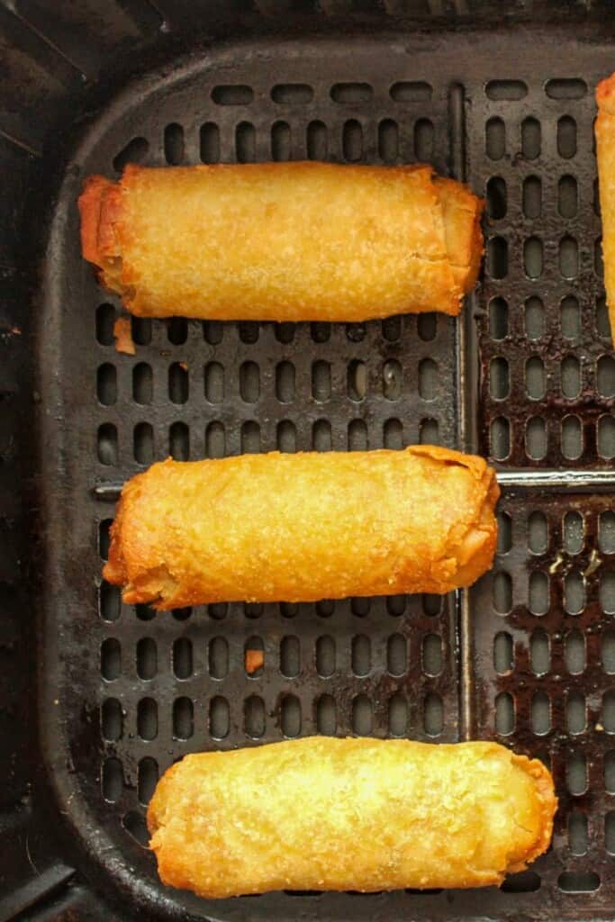 Close up of egg rolls in the air fryer to reheat