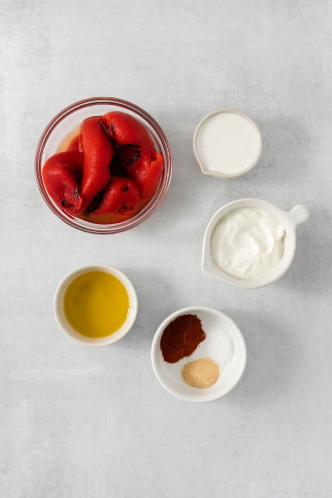Overhead view of the ingredients needed to prepare smoky red pepper crema.