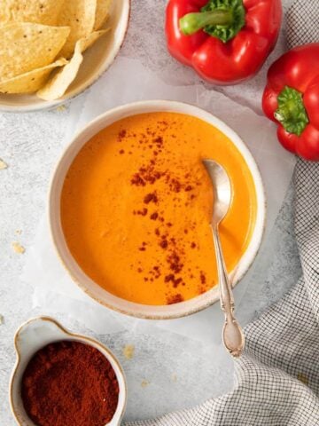 A bowl of prepared smoky red pepper crema with a spoon in it.