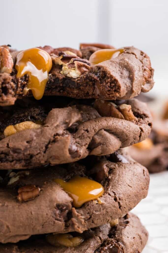 Closeup view of turtle cookies stacked on top of one another.