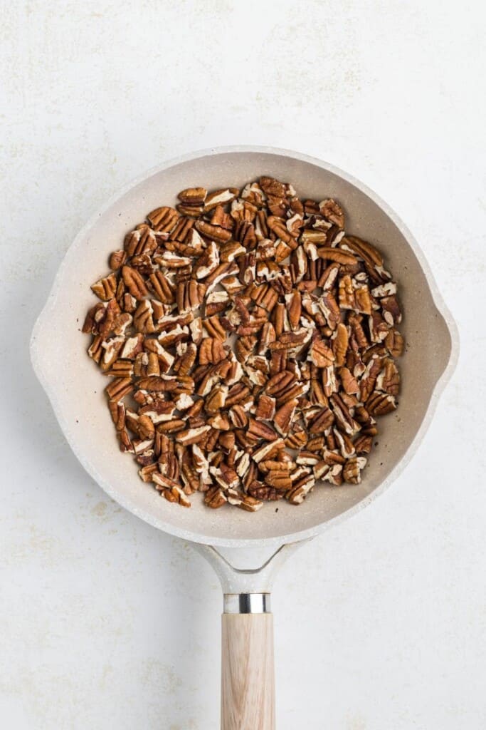 Toasting pecans in a small skillet.