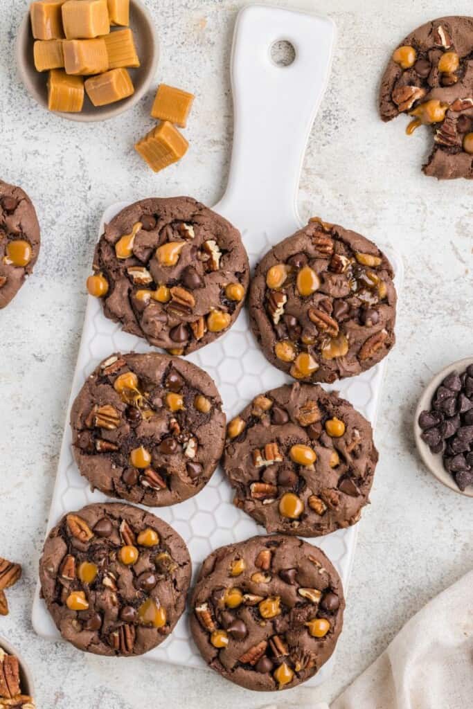 Overhead view of six baked turtle cookies.