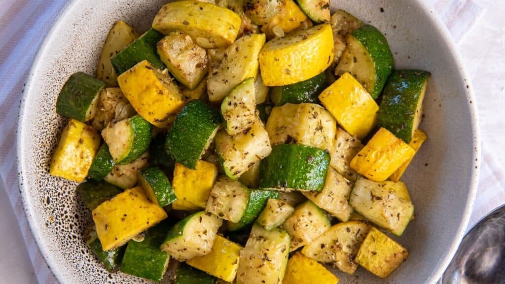Air fryer zucchini and squash cooked and in a bowl.