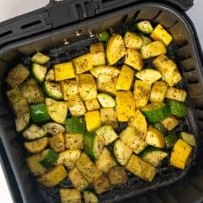 Cooked zucchini and squash in the air fryer basket.