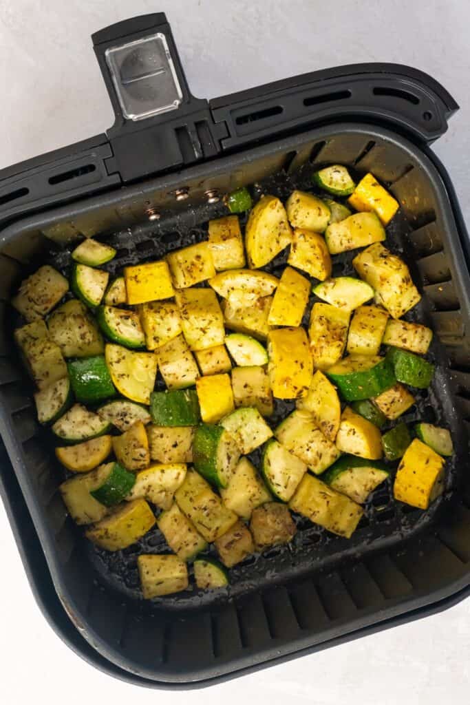 Cooked zucchini and squash in the air fryer basket.