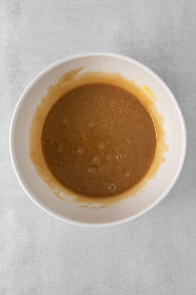 Wet batter in a white bowl to make no butter cookies.