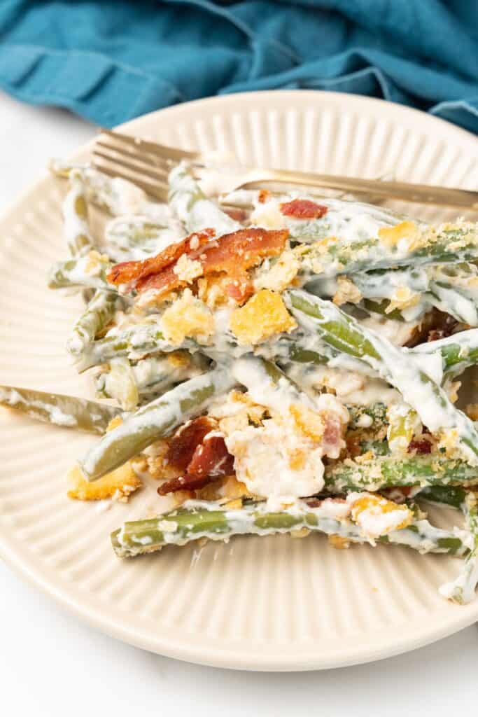 Plated cream cheese green bean casserole on a plate to show how creamy the casserole is.