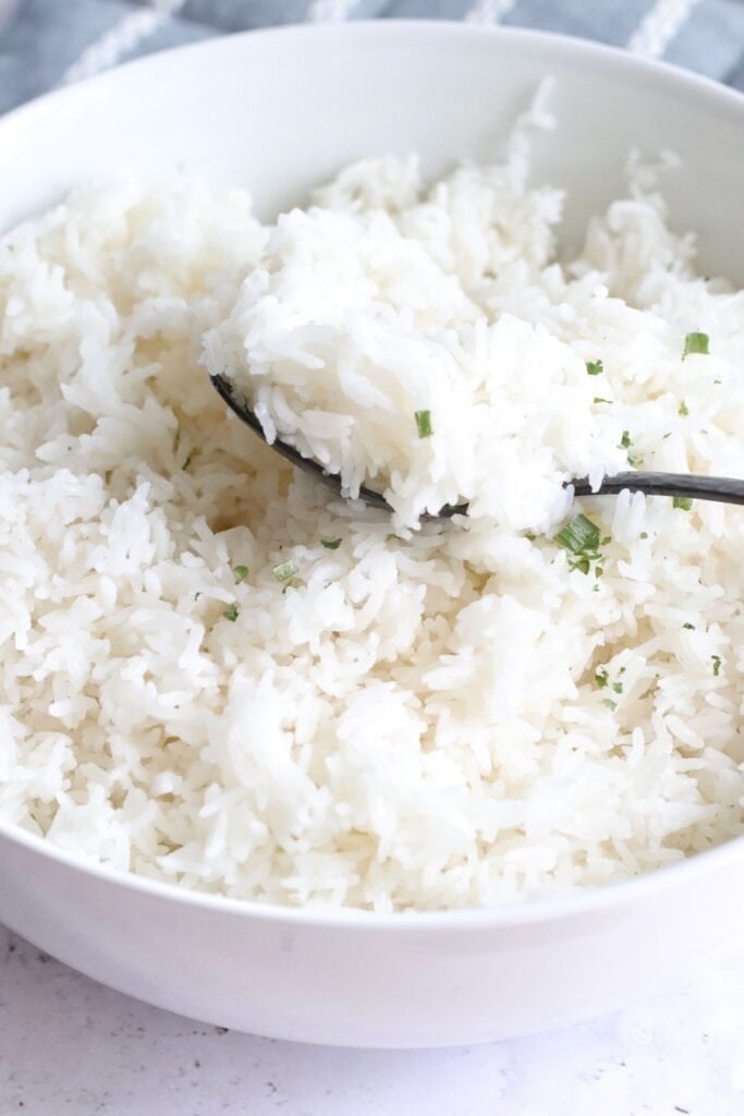Ninja foodi rice in a white bowl with a spoon.