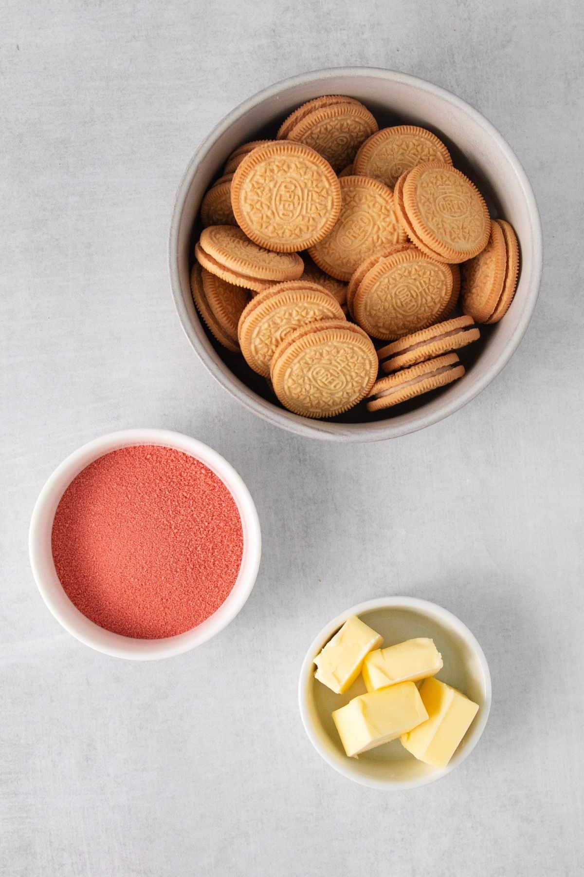 Ingredients needed to make strawberry crunch topping: strawberry jello, golden Oreos, and butter.