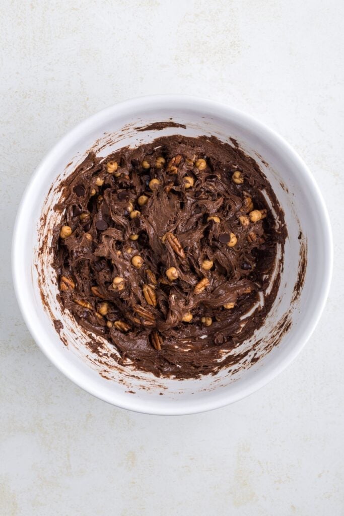 Turtle cookie dough in a mixing bowl ready to be scooped out to make cookies.