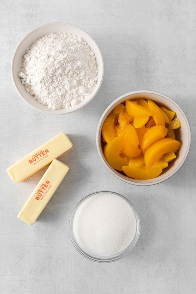 Ingredients needed to make an easy peach cobbler with canned peaches.