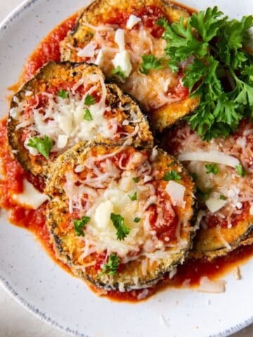 Air fryer eggplant Parmesan on a plate side by side.