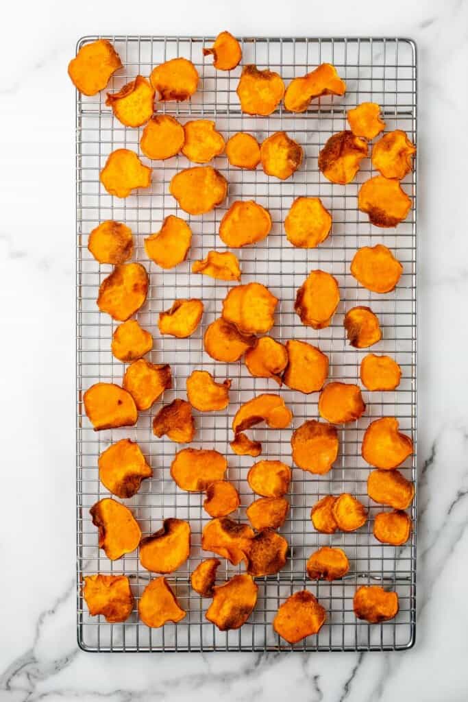 Sweet Potato Chips resting on a cooling rack.