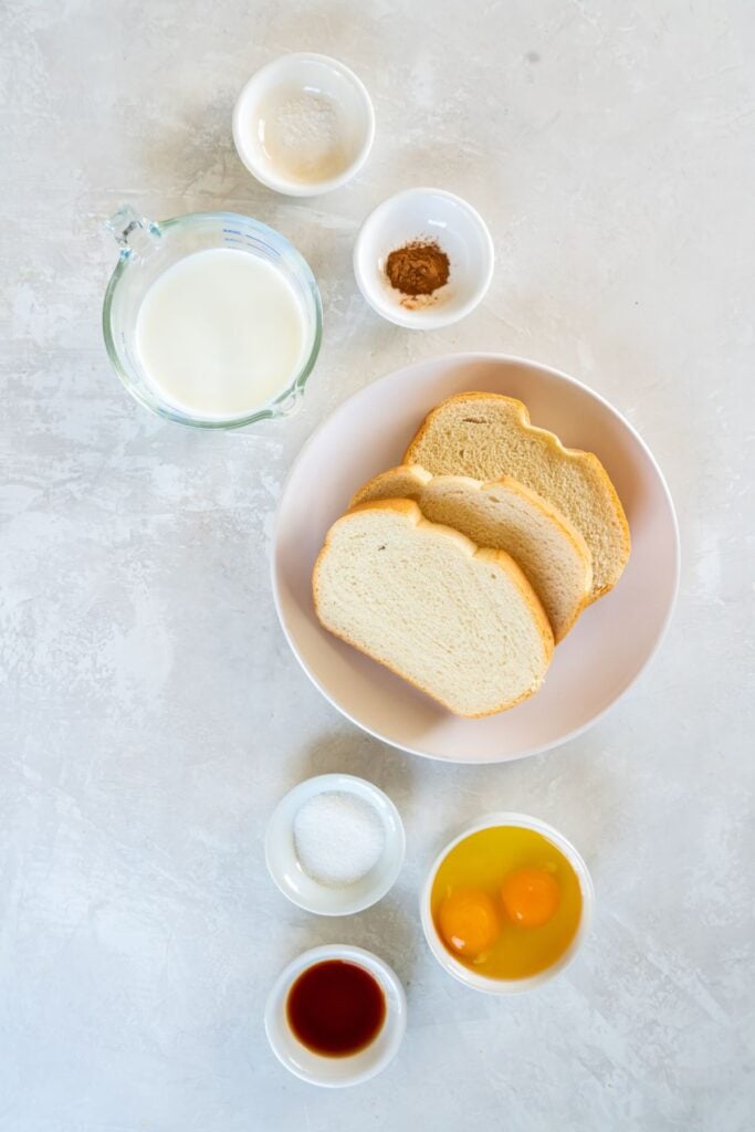 Ingredients needed to make air fryer french toast: bread, milk, eggs, sugar, vanilla, cinnamon, and salt.