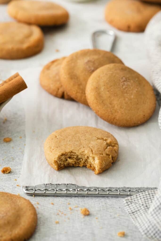 Closeup view of a snickerdoodle cookie with one bite removed.