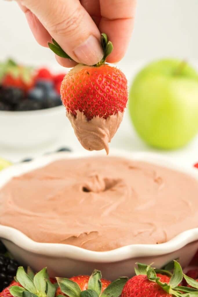A strawberry dipped in chocolate fruit dip.